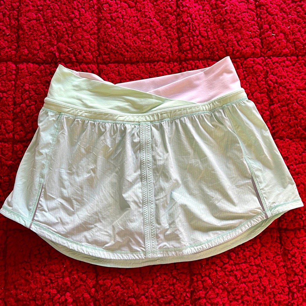 Cute light green Lululemon tennis skirt with shorts and pockets on each side!